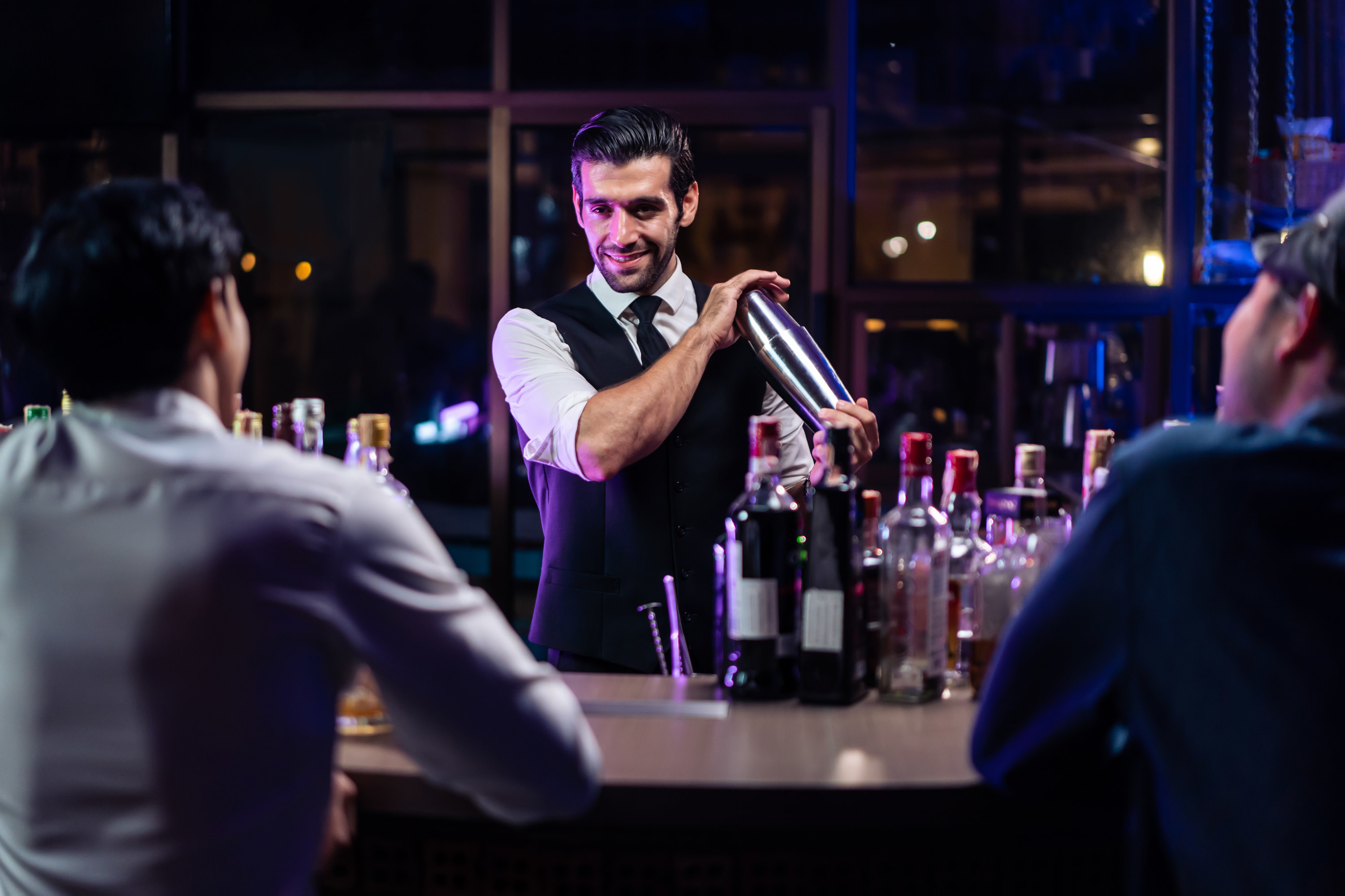 A bartender making a cocktail