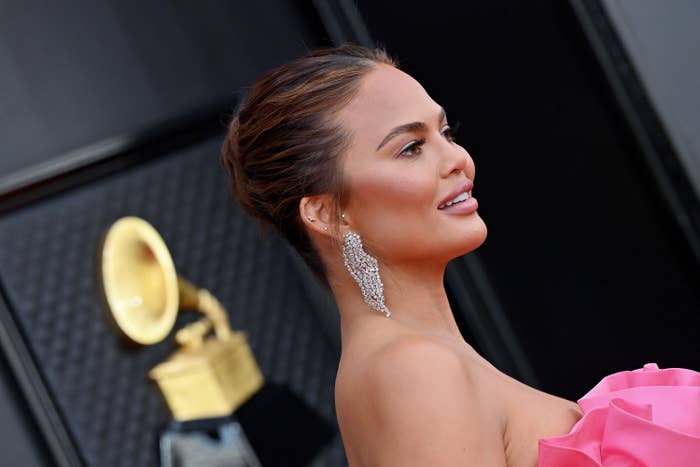 A close-up side view of Chrissy in a strapless outfit