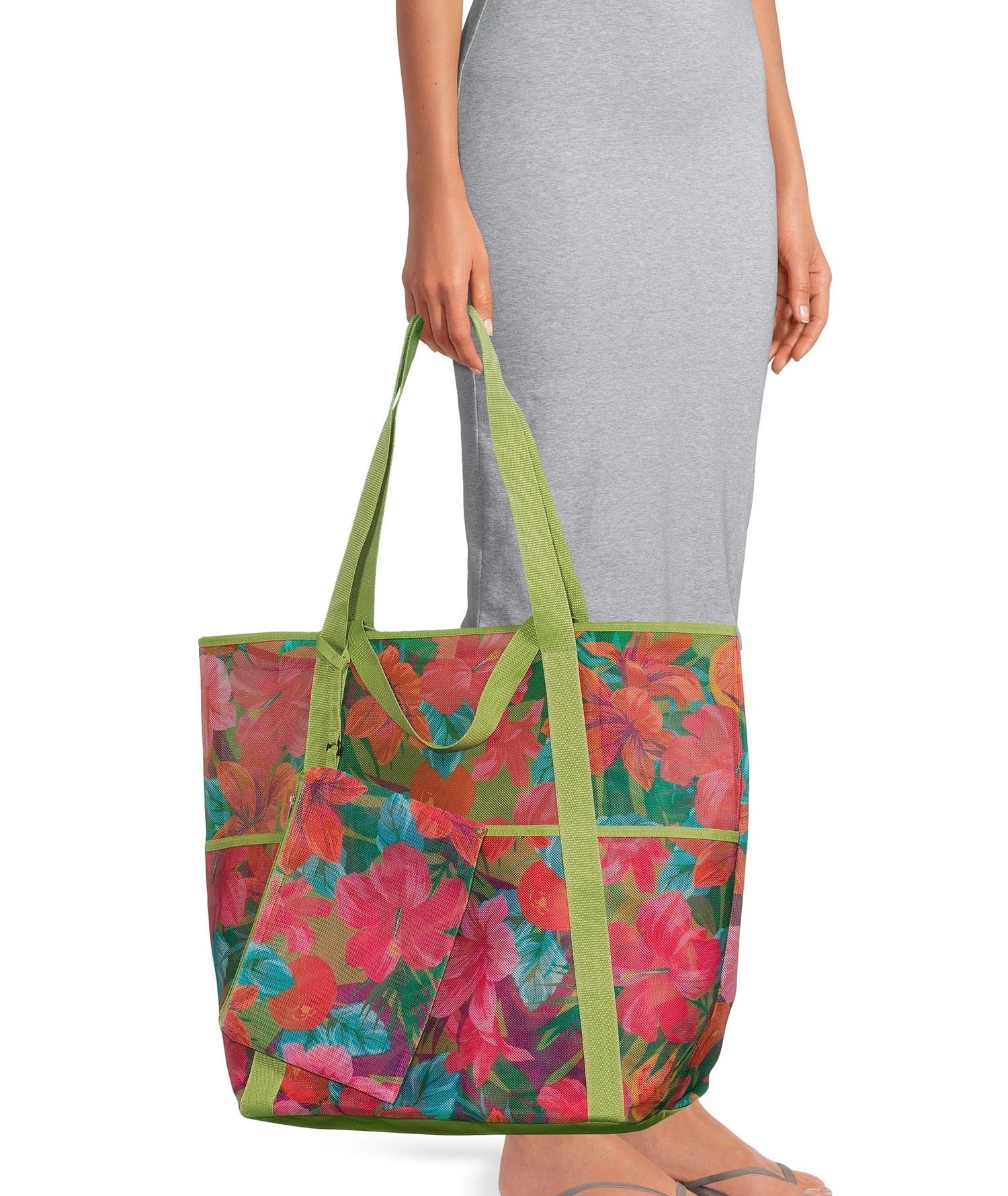 a model holding the tote featuring a multicolor floral print