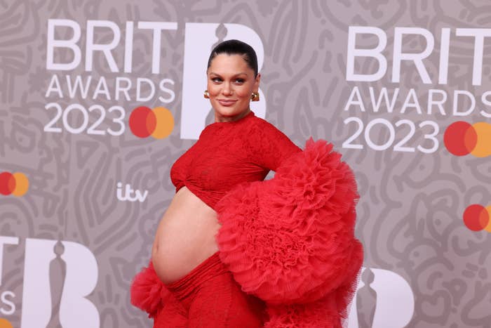Jessie J at the BRIT Awards and wearing an outfit with puffy arms that shows her pregnant belly