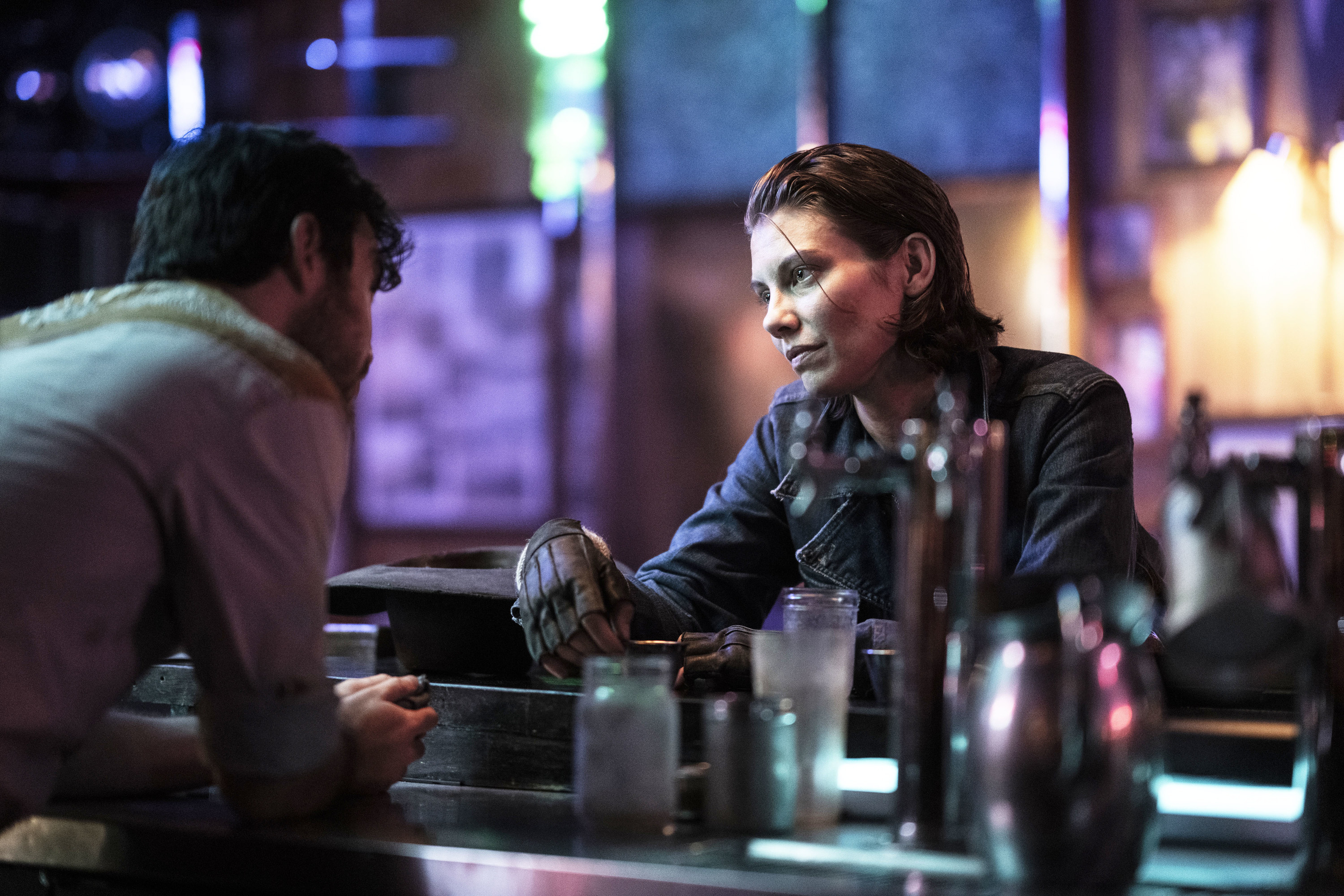 maggie talking to someone across a bar