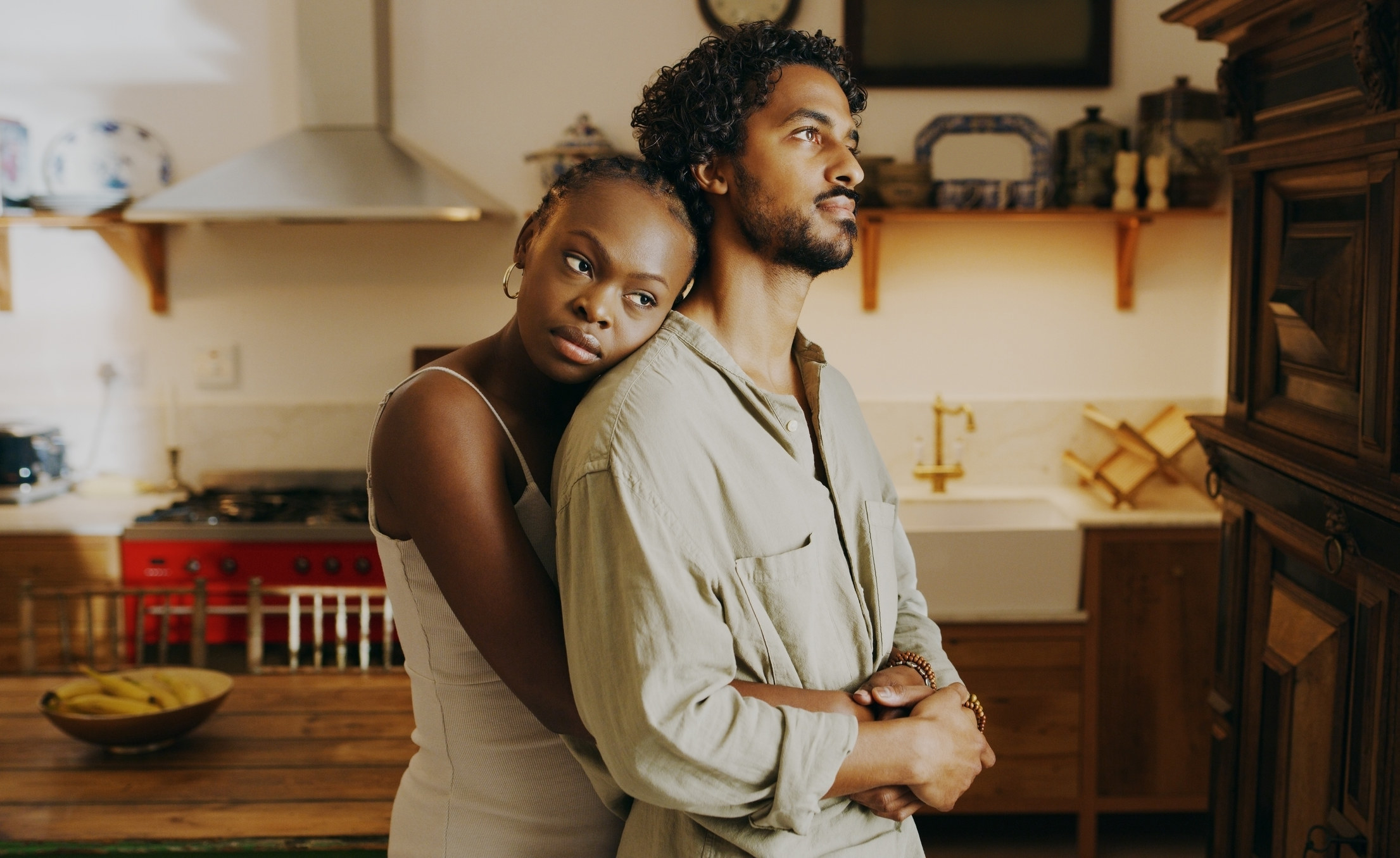 Unhappy couple hugging each other in a kitchen