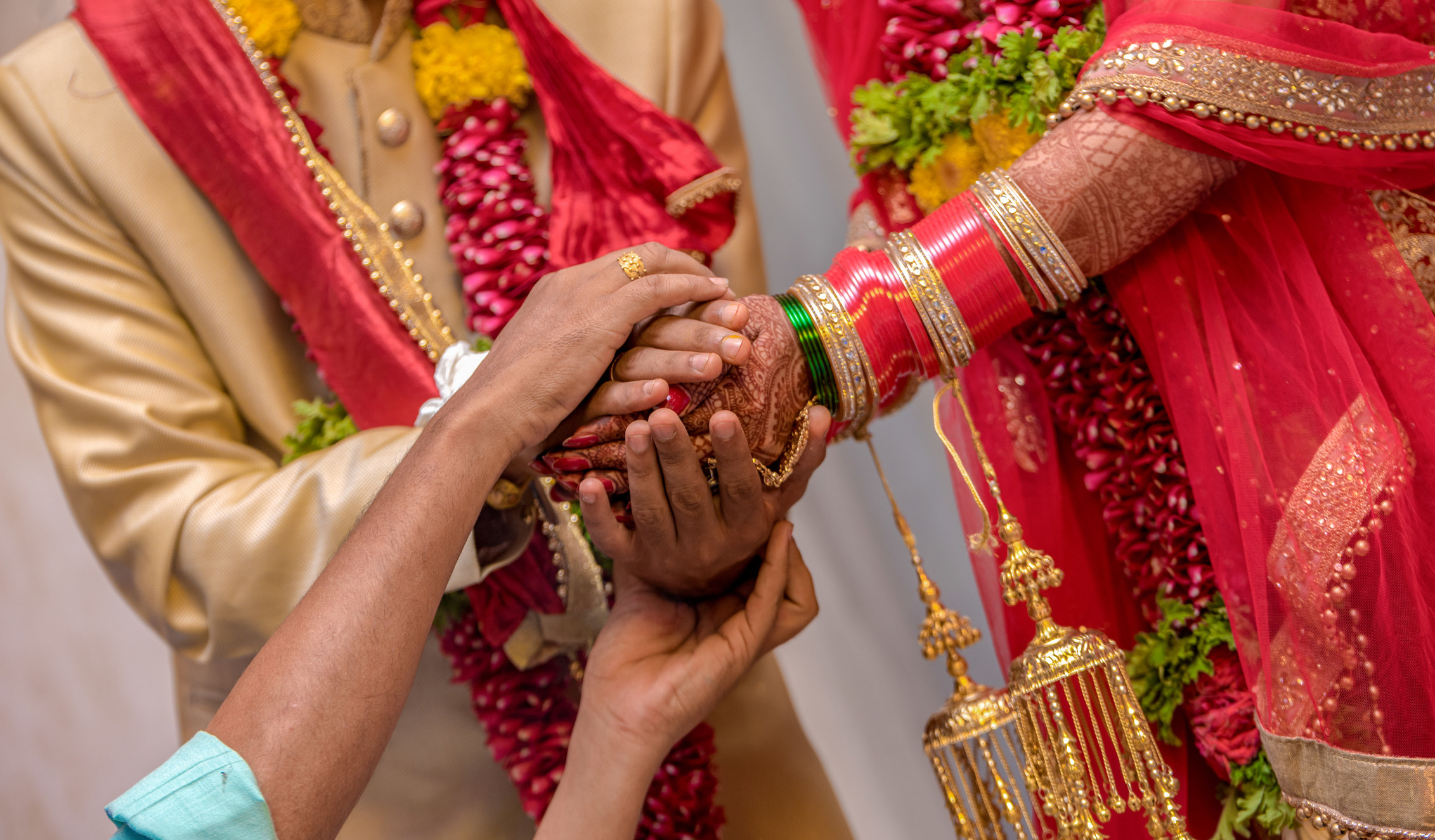 Close-up of Indian wedding, hands embracing