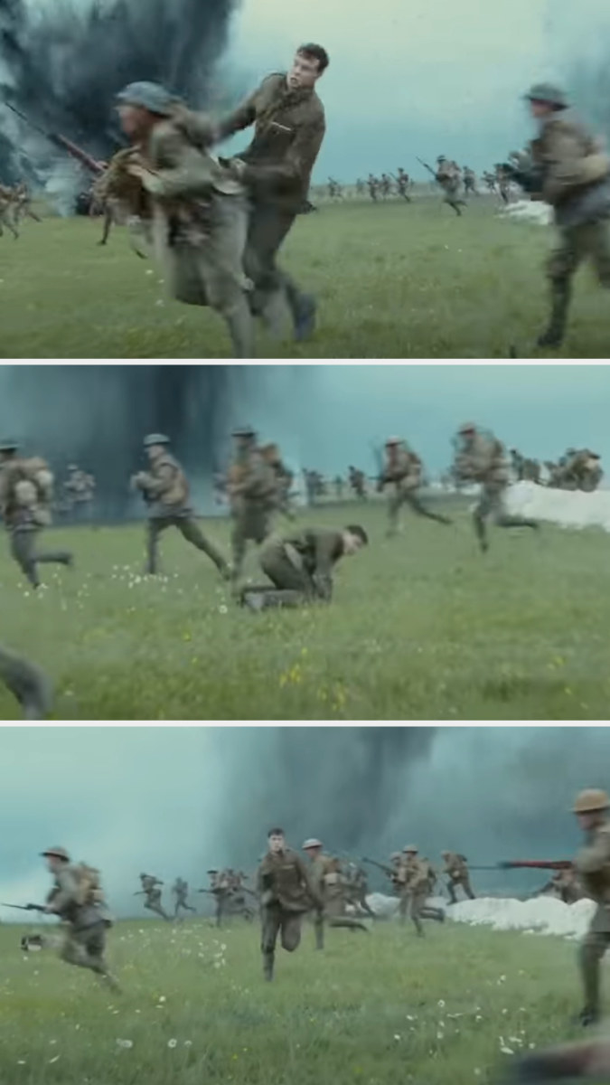 soldiers running in the field and one of them falling