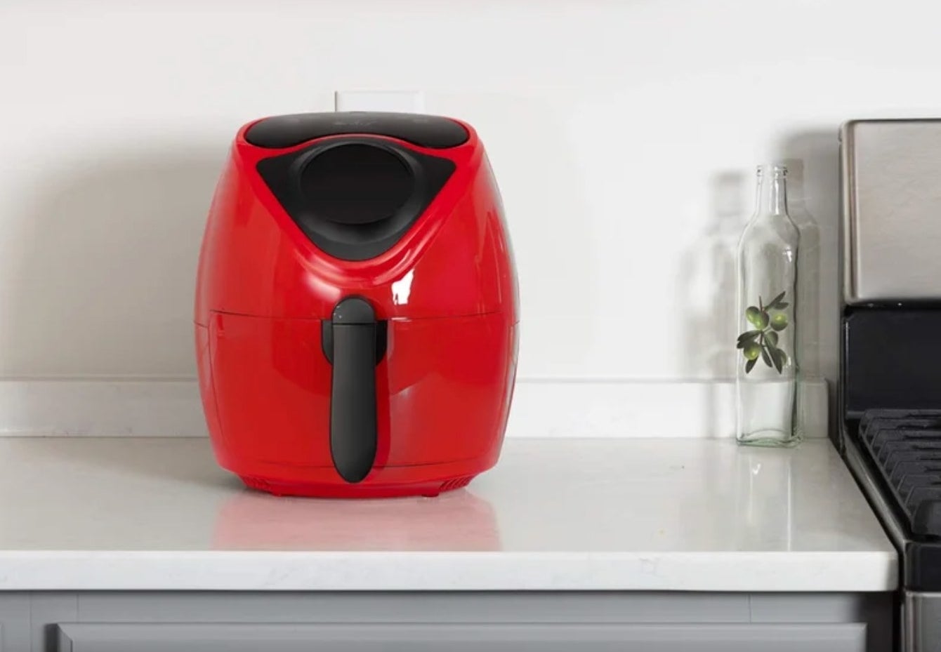 the red air fryer on a kitchen counter