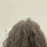 Claudia flips her hair over while looking shocked
