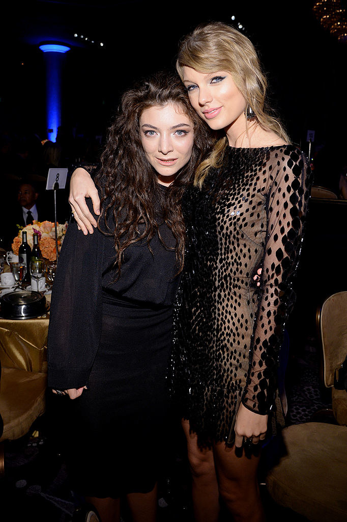 taylor with her arm around lorde at an event