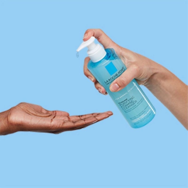 A person pouring out cleanser
