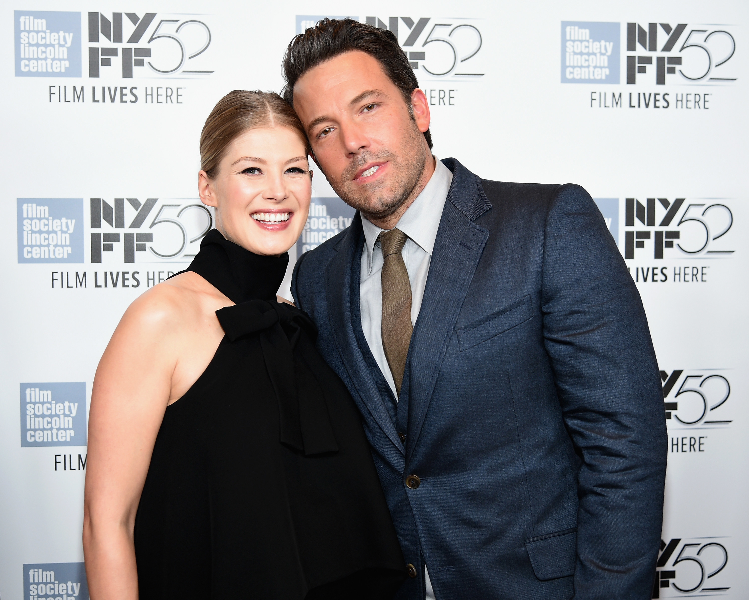 Rosamund and Ben with their heads pressed together at a press event