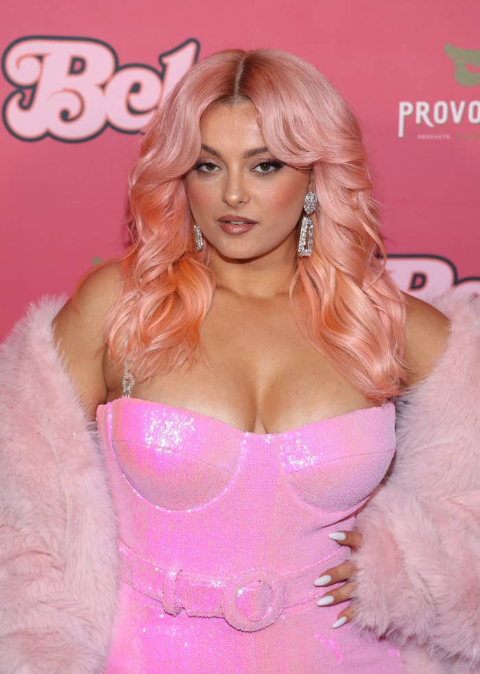 Close-up of Bebe in a shiny spaghetti-strap outfit and furry wrap