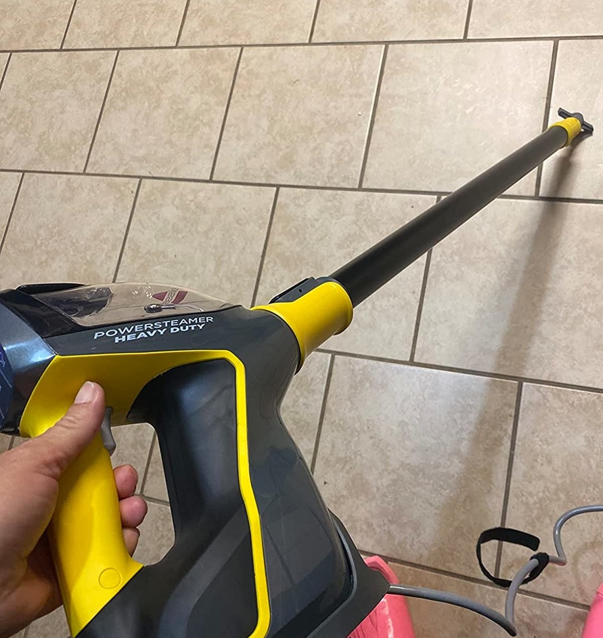 a reviewer using the steam mop on their floor grout