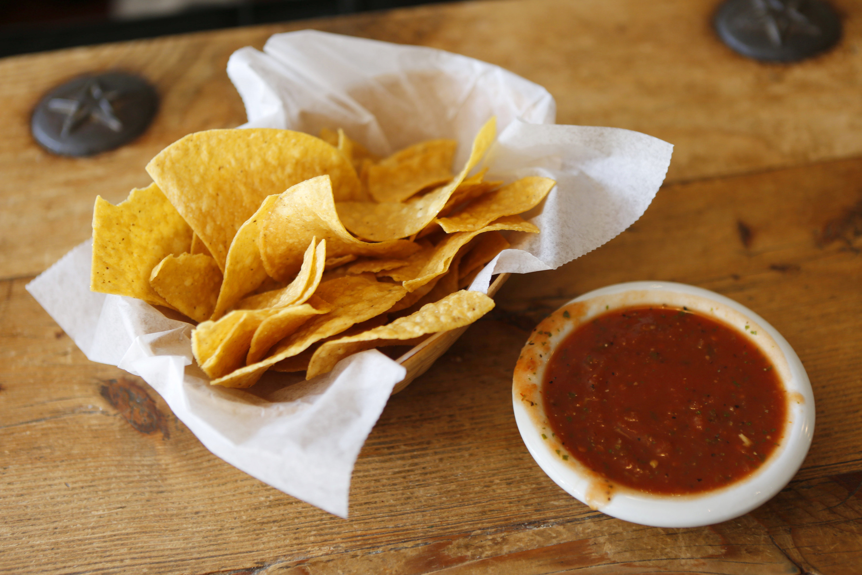 Basket of chips and a side of red salsa
