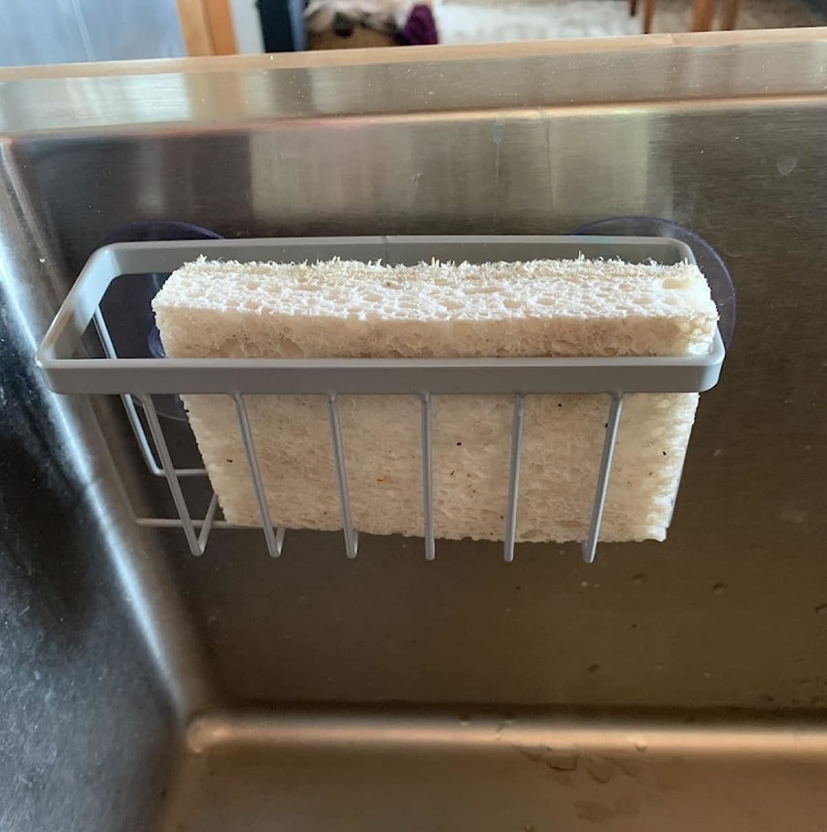 a reviewer&#x27;s photo of the sponge holder on their sink