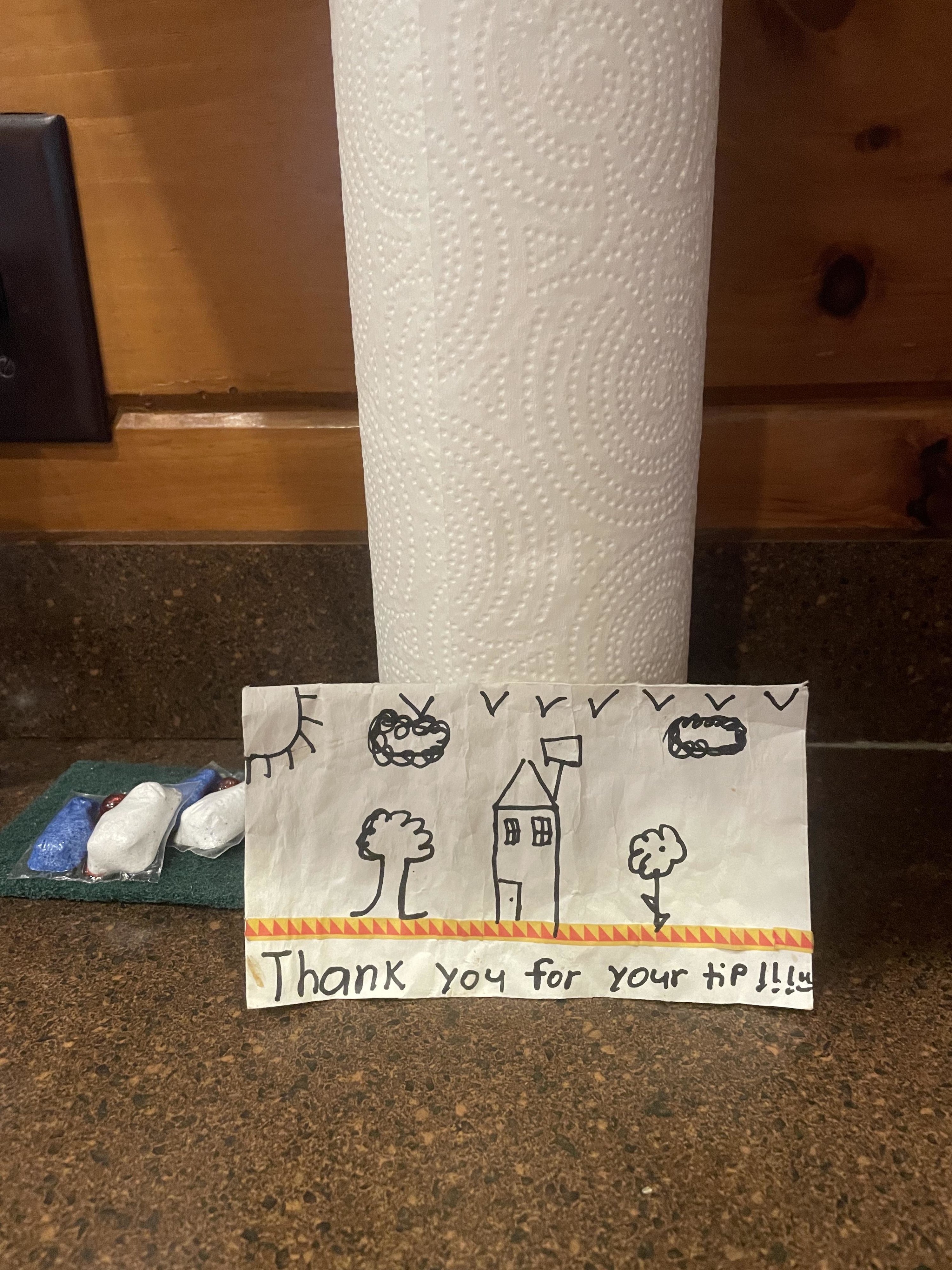 note with a kid drawing of a house and trees