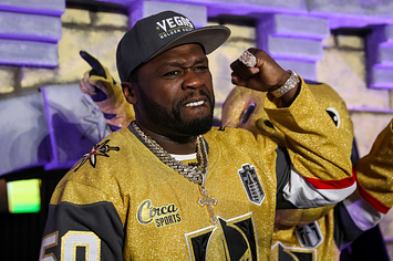 Photo of 50 Cent with a gold hockey jersey