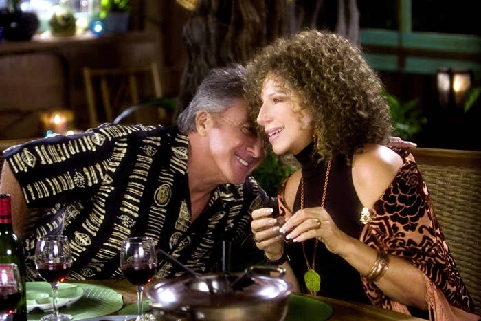 Dustin Hoffman and Barbra Streisand sitting at a table with wine in Meet the Fockers