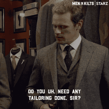 Actor Sam Heughan asking if someone needs any tailoring done while wearing a perfectly tailored suit himself