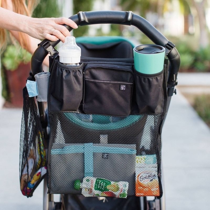 Mesh organizer hangs on the back of a stroller