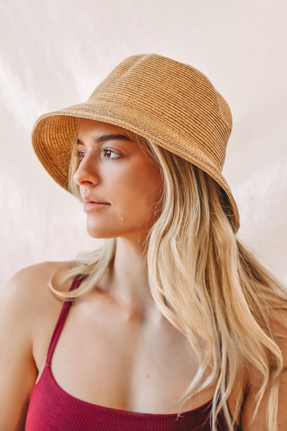 Model wearing straw bucket hat