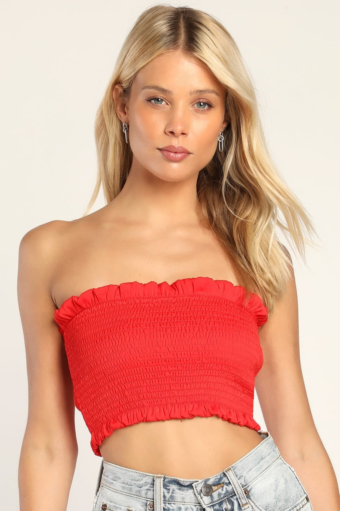 Model wearing red smocked tube top