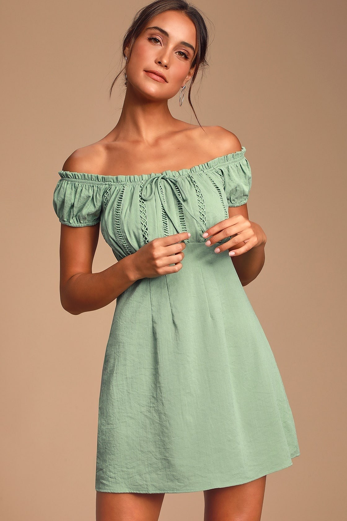 Model wearing off the shoulder green mini dress