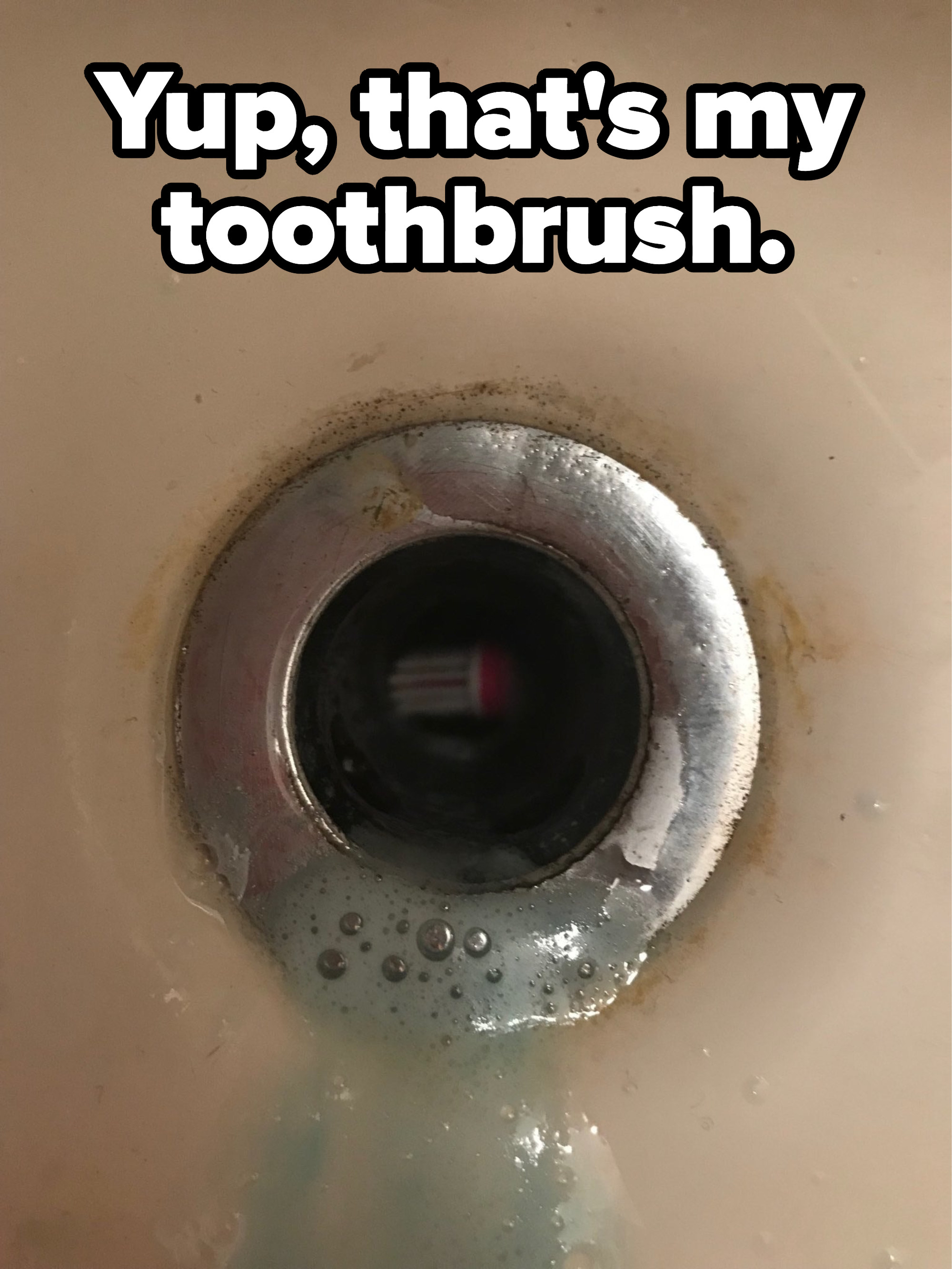 A toothbrush in a drain