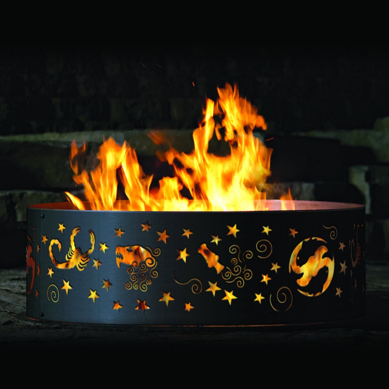 a black metal ring fire pit with a Zodiac design cut into the sides