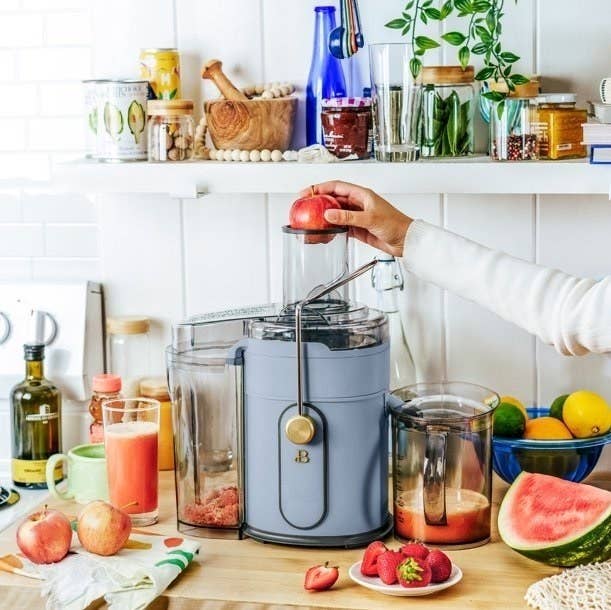 The juicer in blue making apple juice