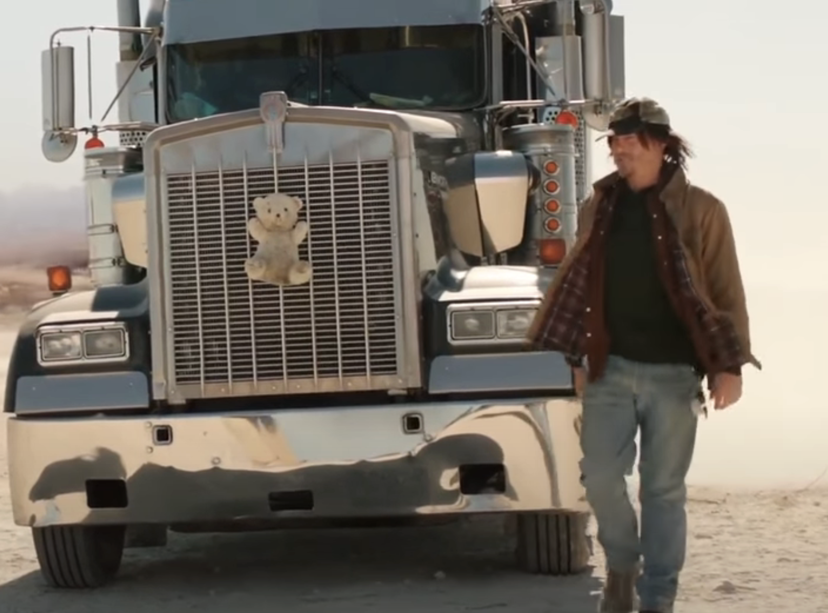 A man standing next to a big rig truck