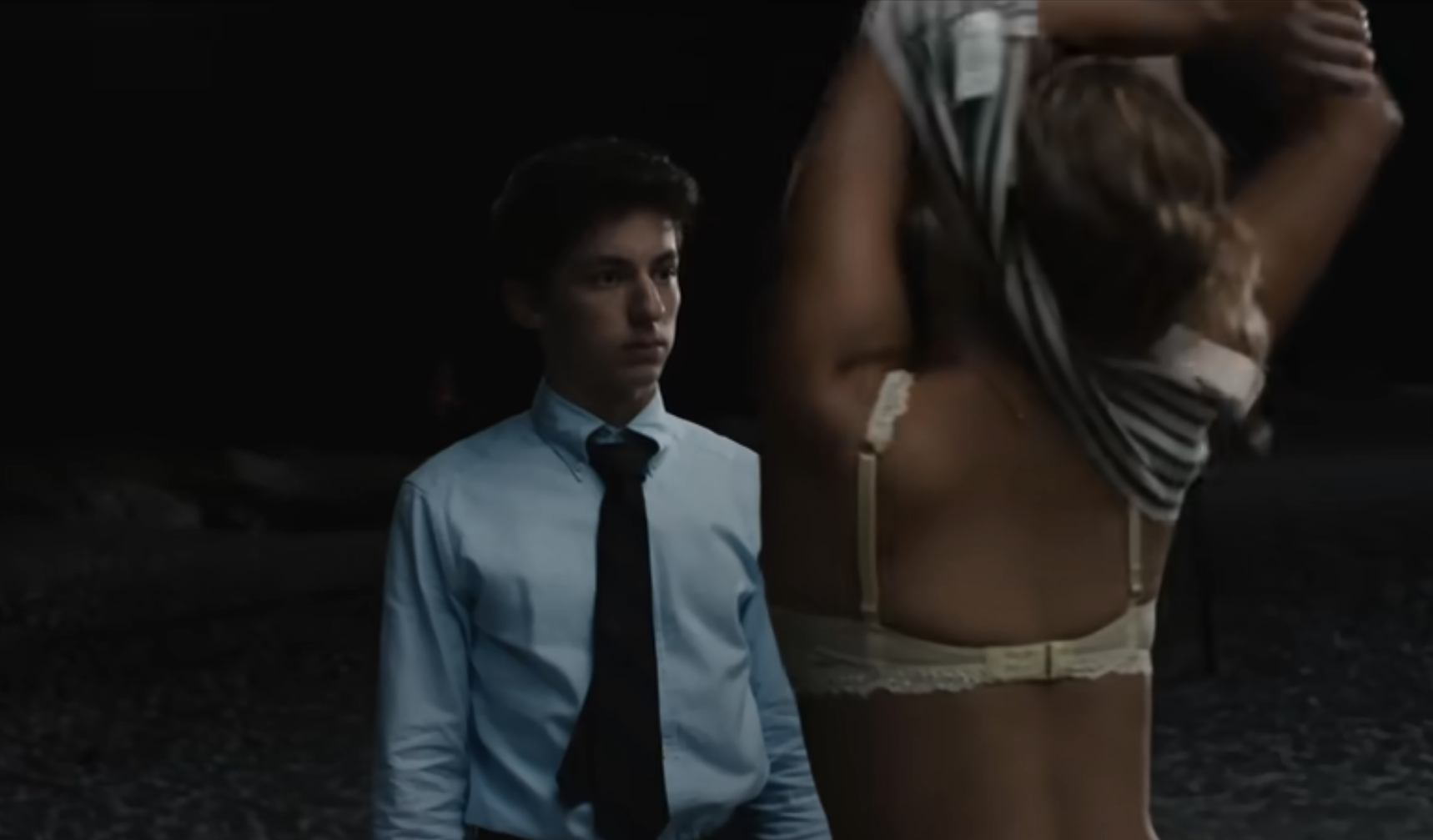 Maddie takes her top off as Percy looks on in a scene from the film
