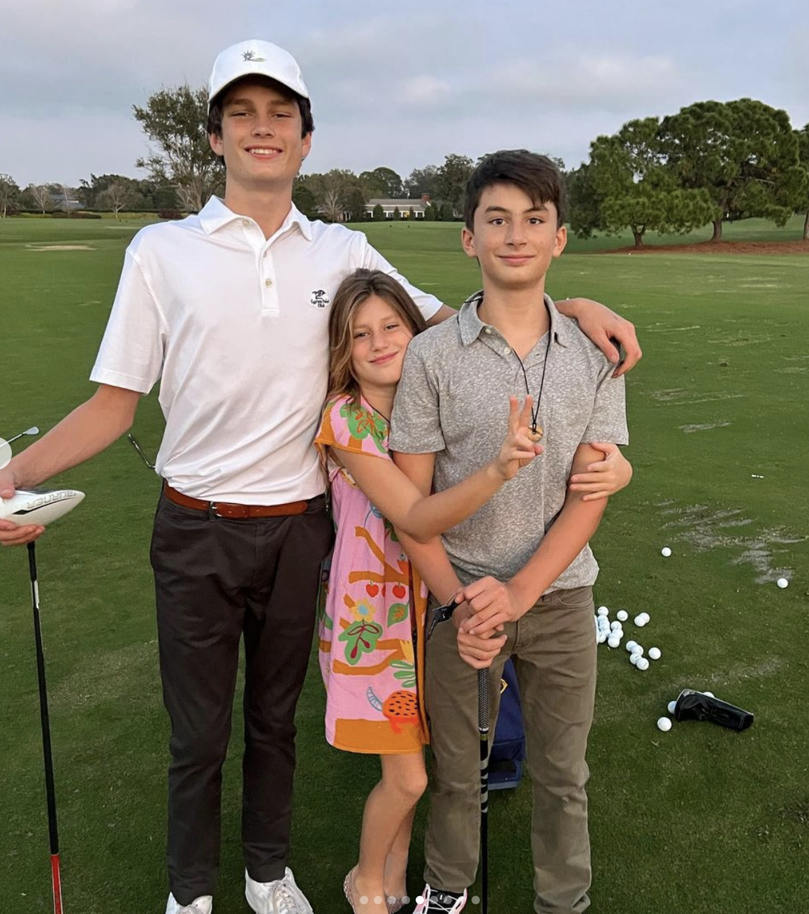 Benjamin, Vivian, and Jack on a golf course