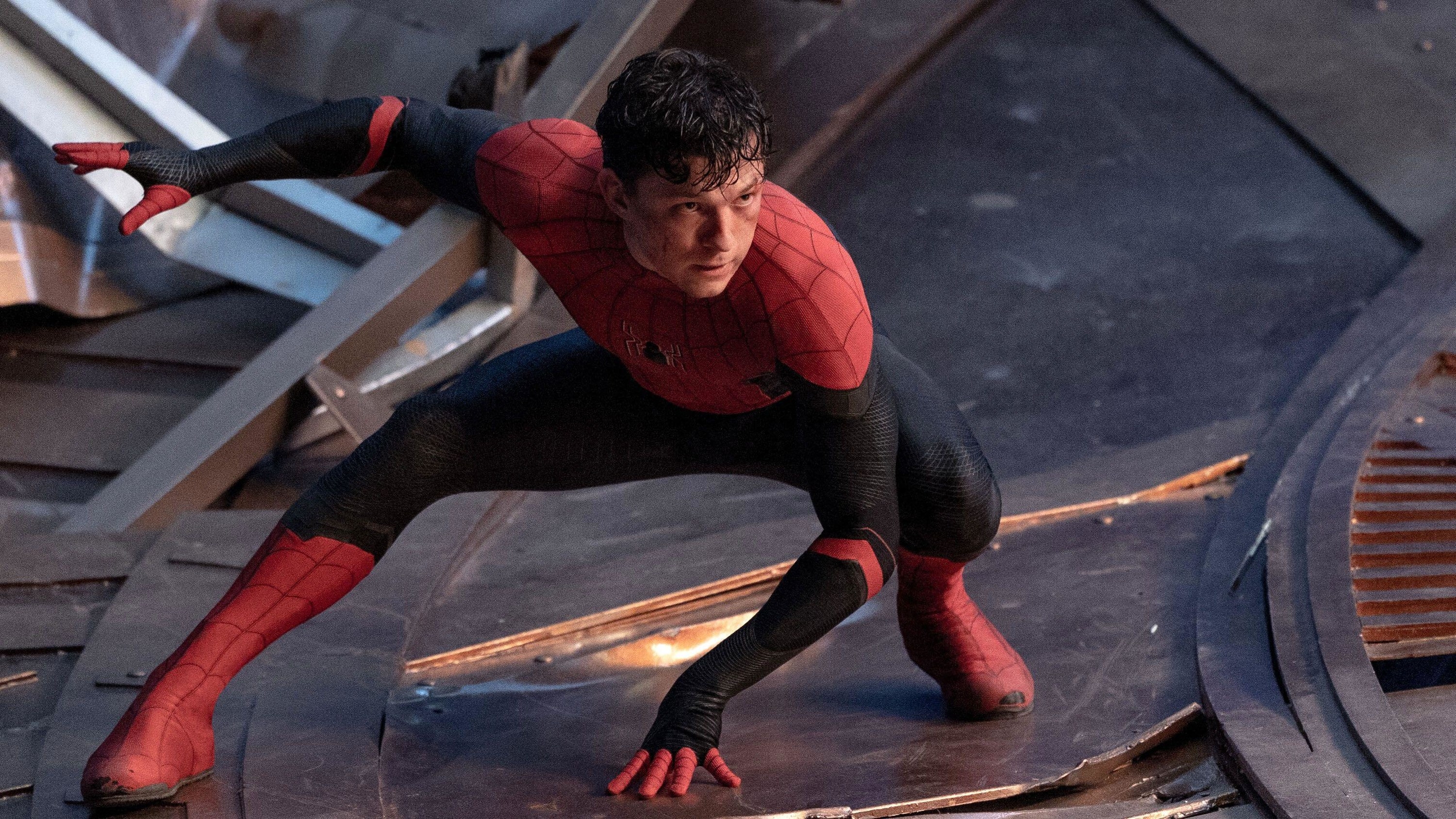 Tom Holland crouches in his signature pose as Spider-Man