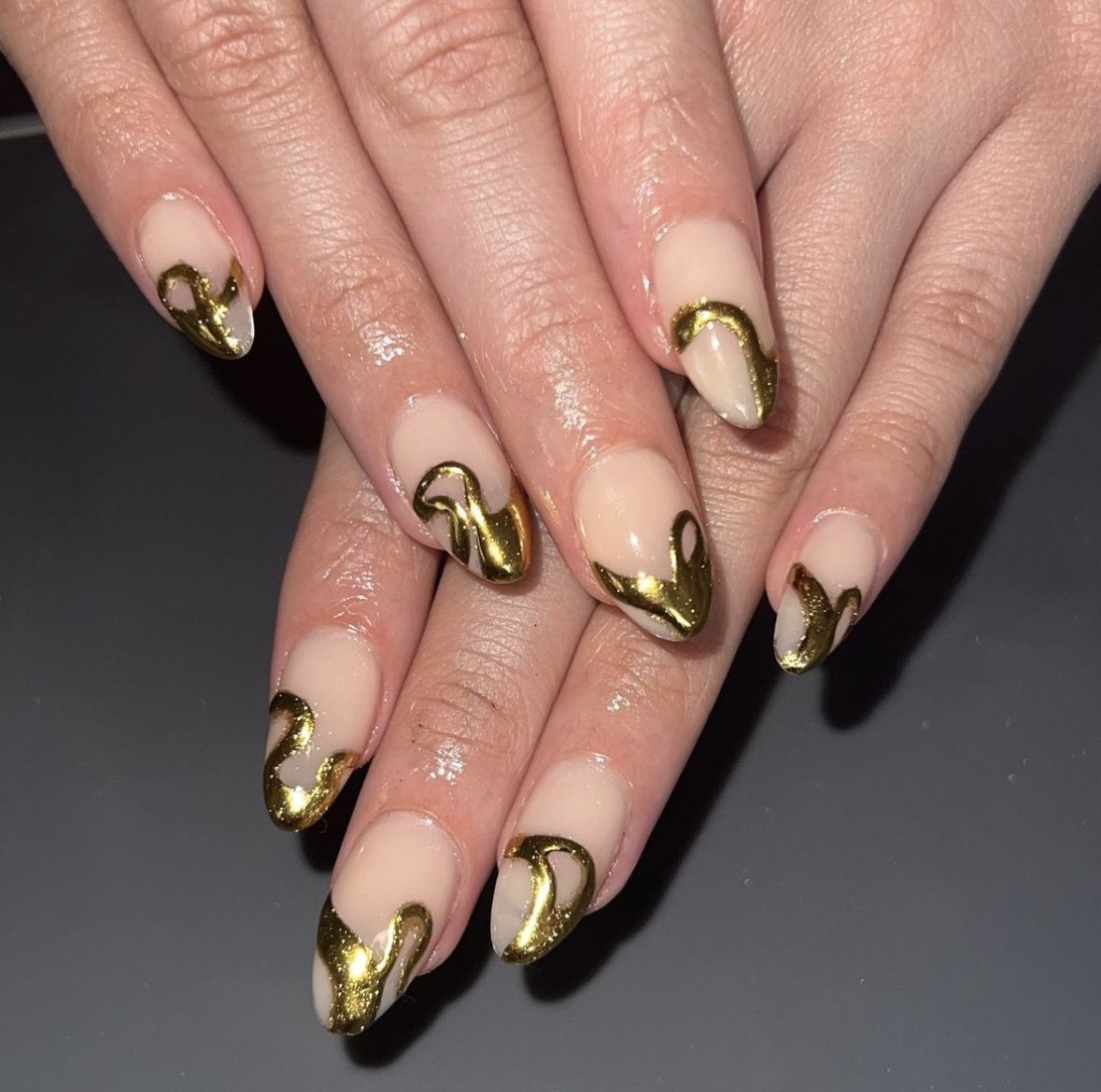 a picture of manicured nails with chrome design