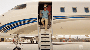 GIF of Brooklyn Nine-Nine characters Jake Peralta and Doug Judy getting off a plane
