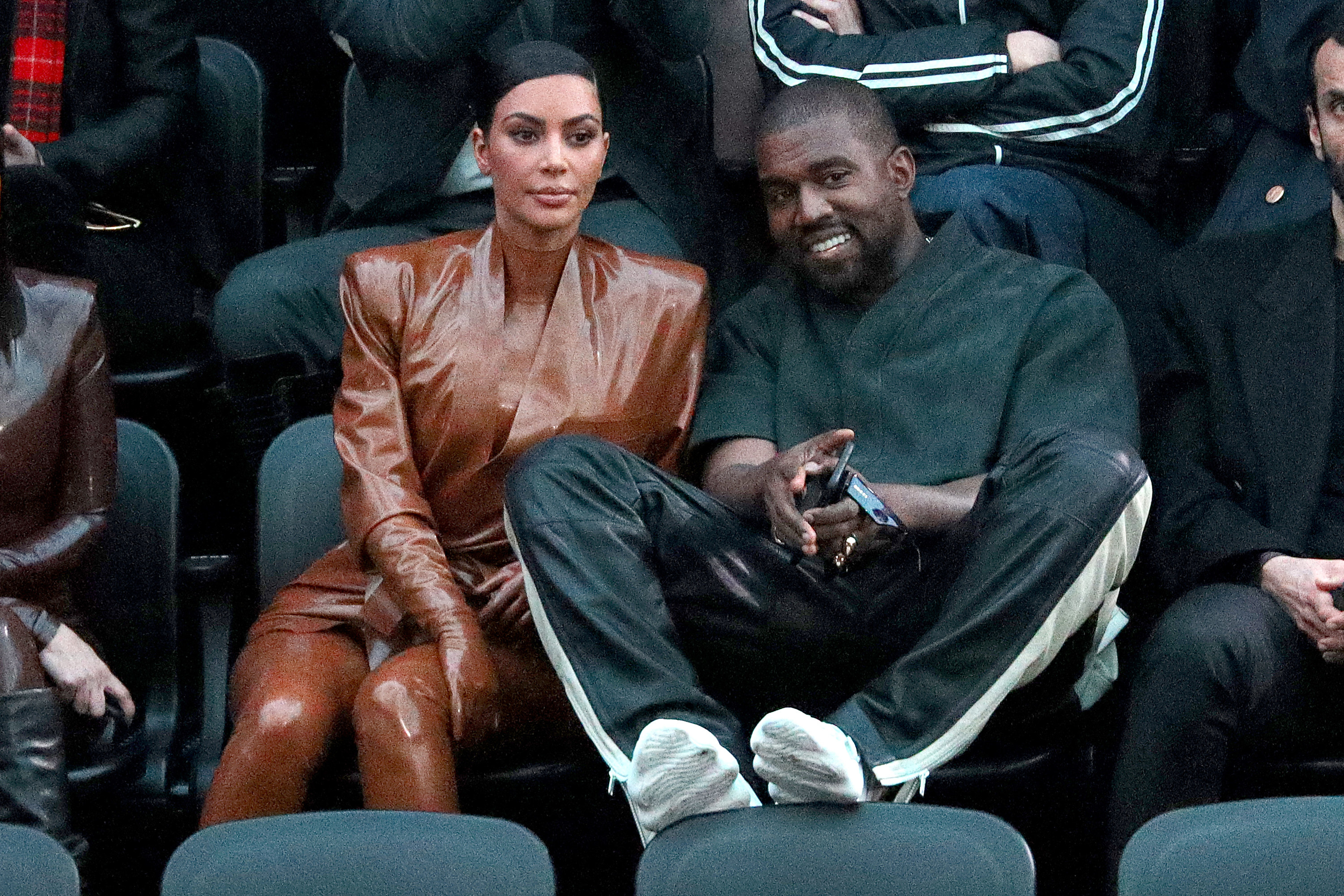Kanye and Kim sit next to each other