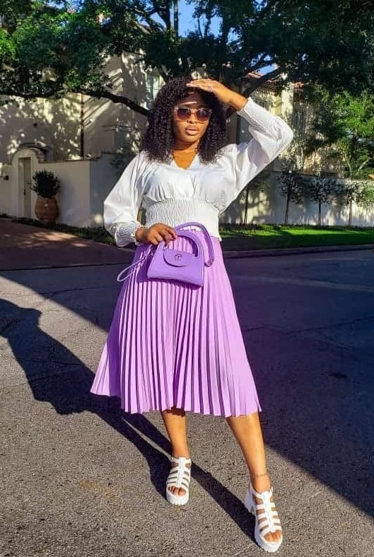 A reviewer in the lavender midi skirt