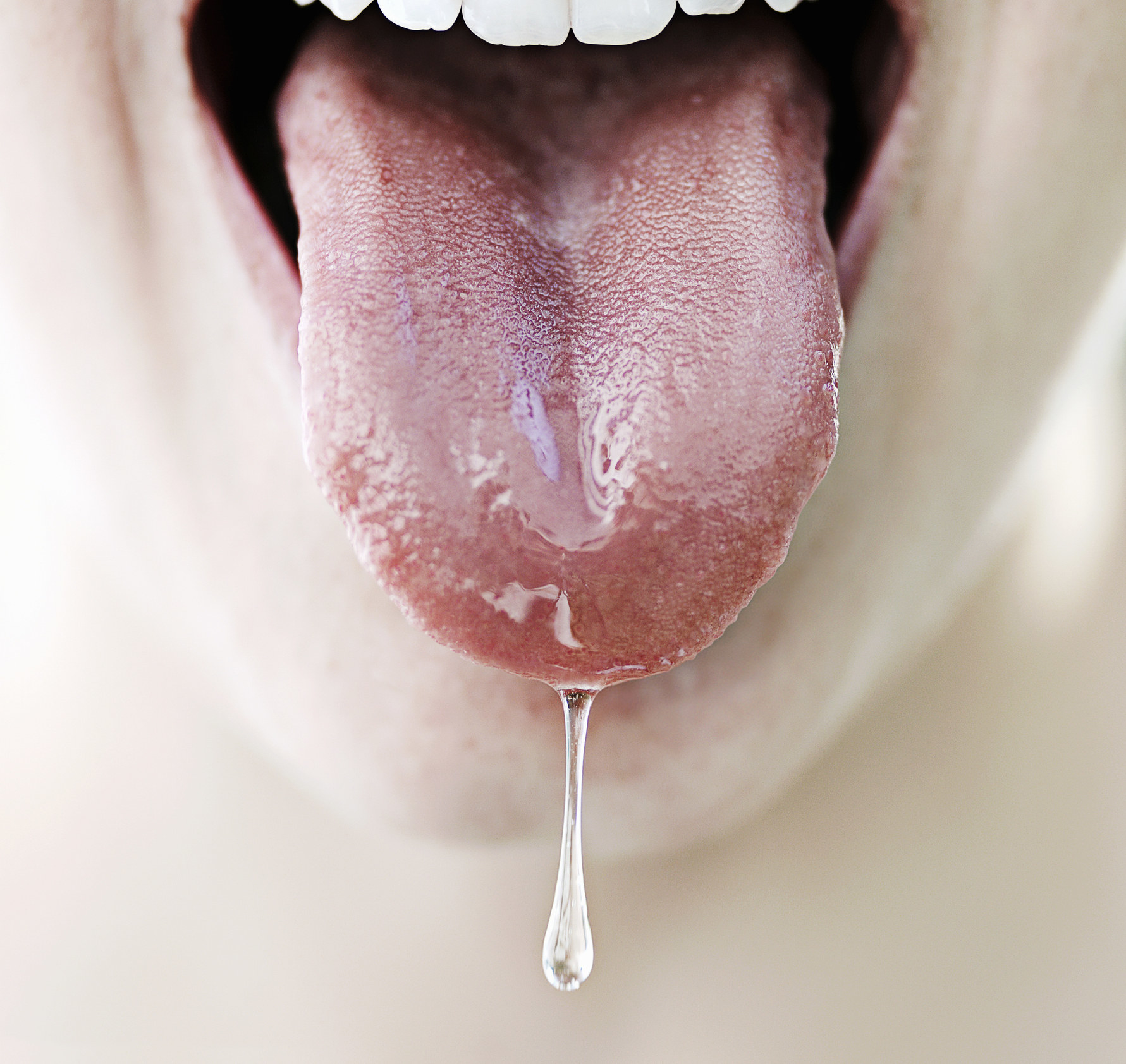 Closeup of a tongue salivating