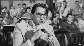 Atticus Finch unfolding his hands in the courtroom.