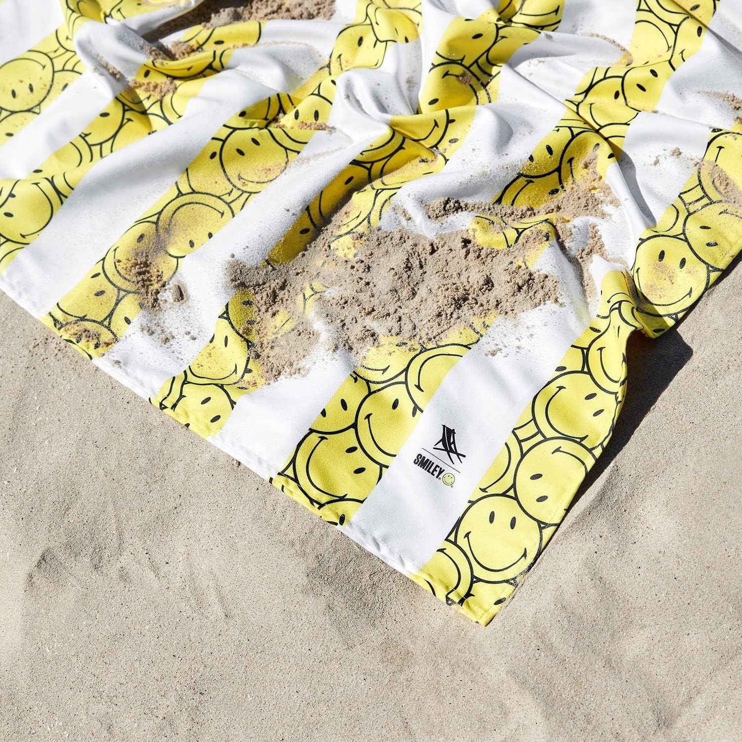 the smiley face print towel in the sand