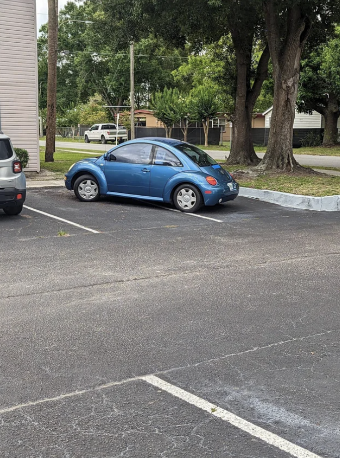 A car parked badly in a parking spot