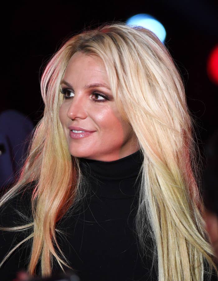Close-up of Britney in a turtleneck looking to the side