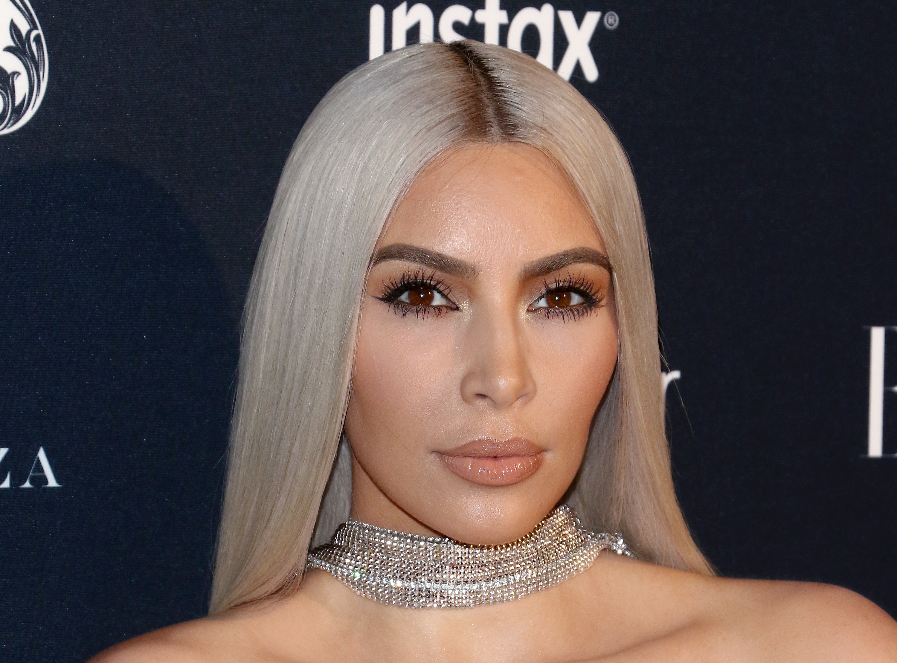 Close-up of Kim wearing a thick choker necklace