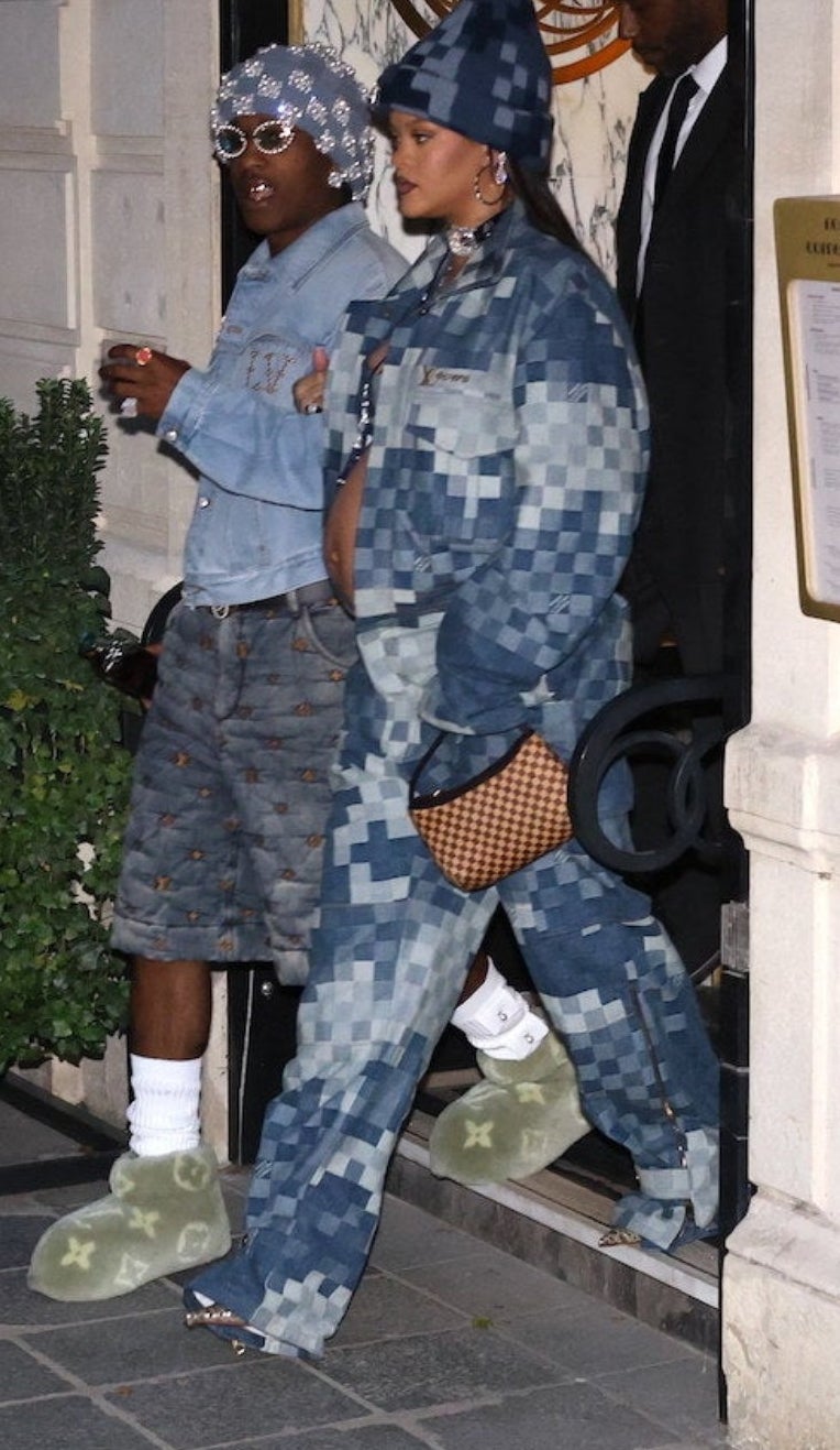Rihanna in a blurry denim outfit and walking alongside A$AP in baggy knee-length denim shorts and a denim jacket