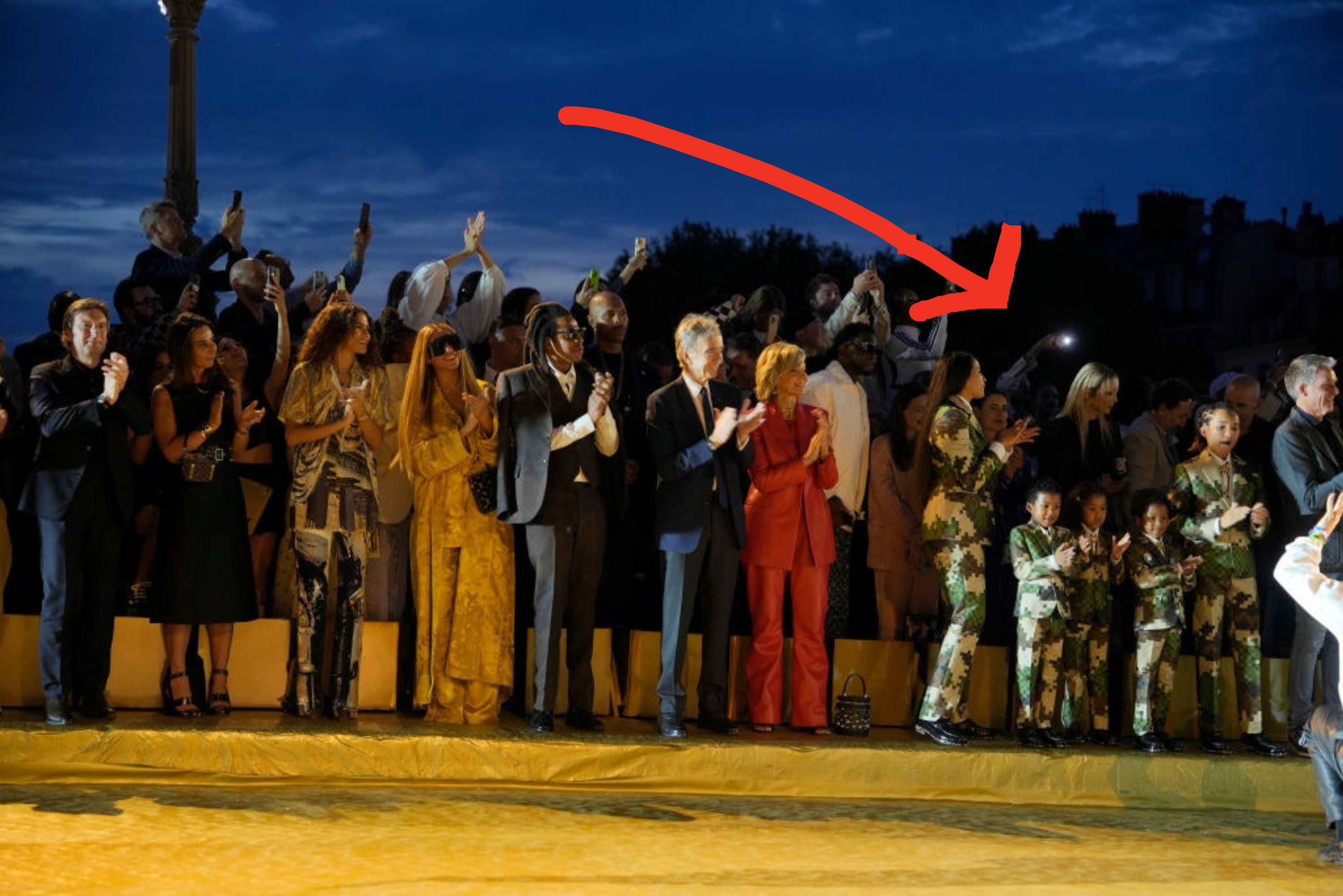 Zendaya, Beyoncé, and Jay-Z at the Louis Vuitton show, with arrow pointing to adults and children in fatigues