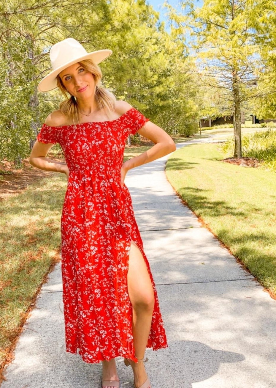 a reviewer wearing the red floral dress