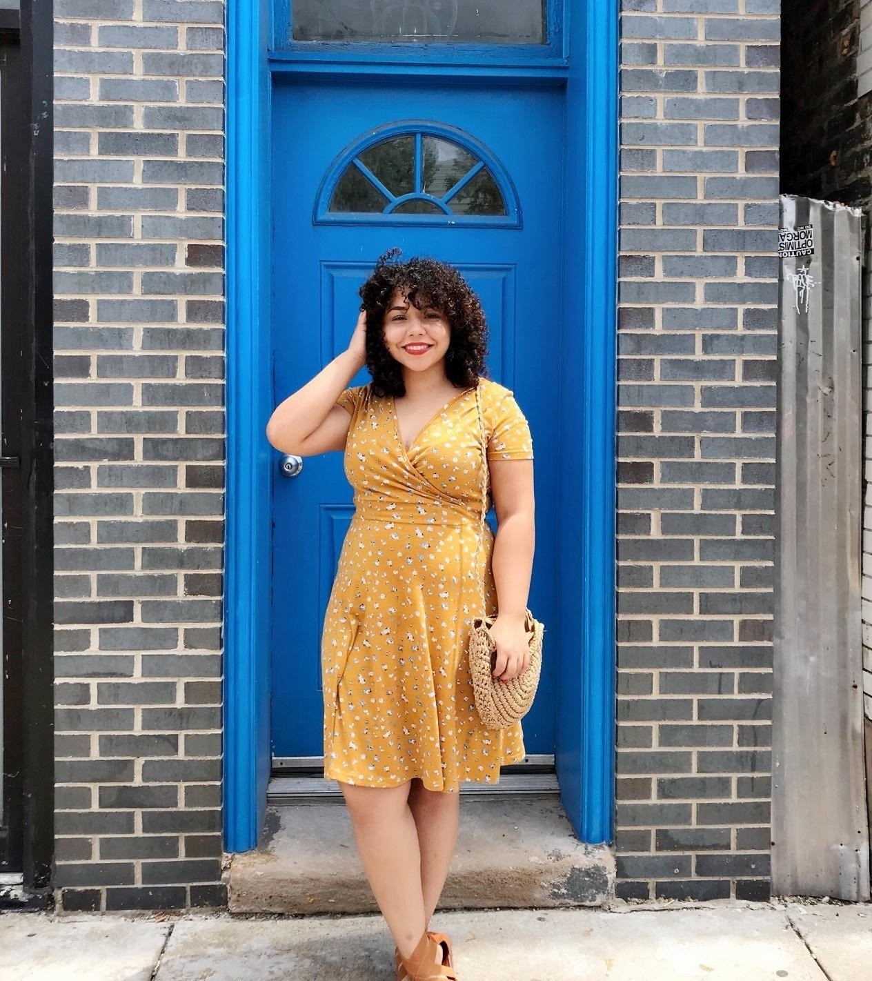 a reviewer wearing the yellow floral dress