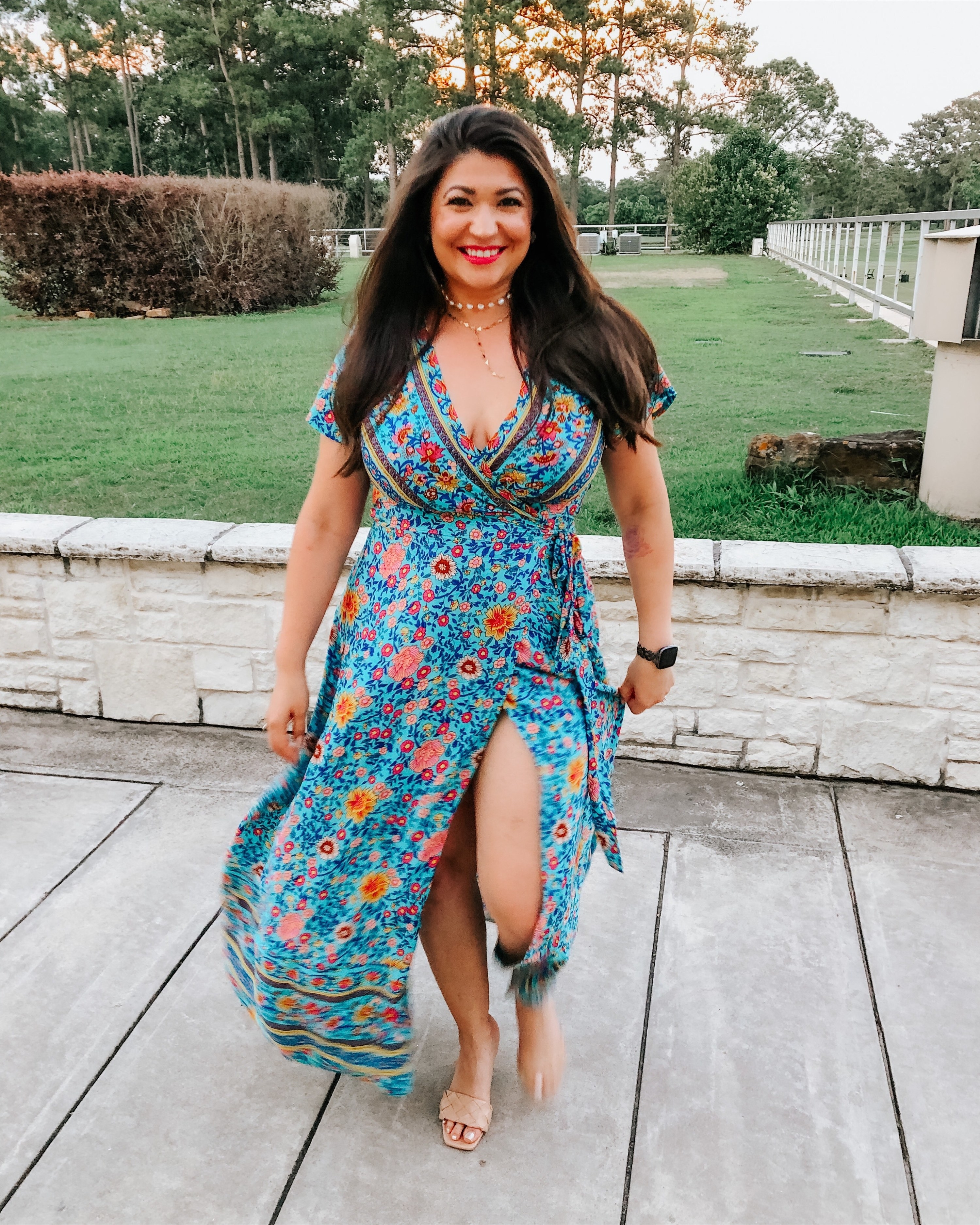 reviewer wearing the turquoise floral dress