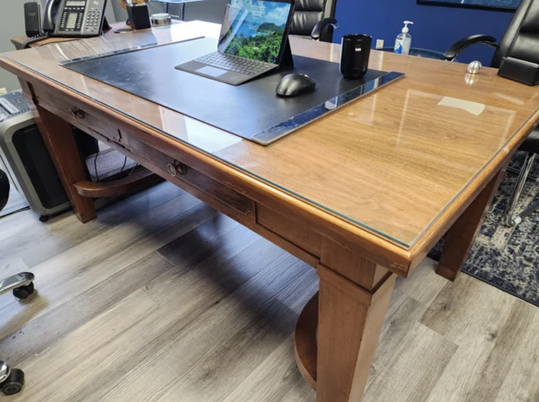 An old desk with a glass topper