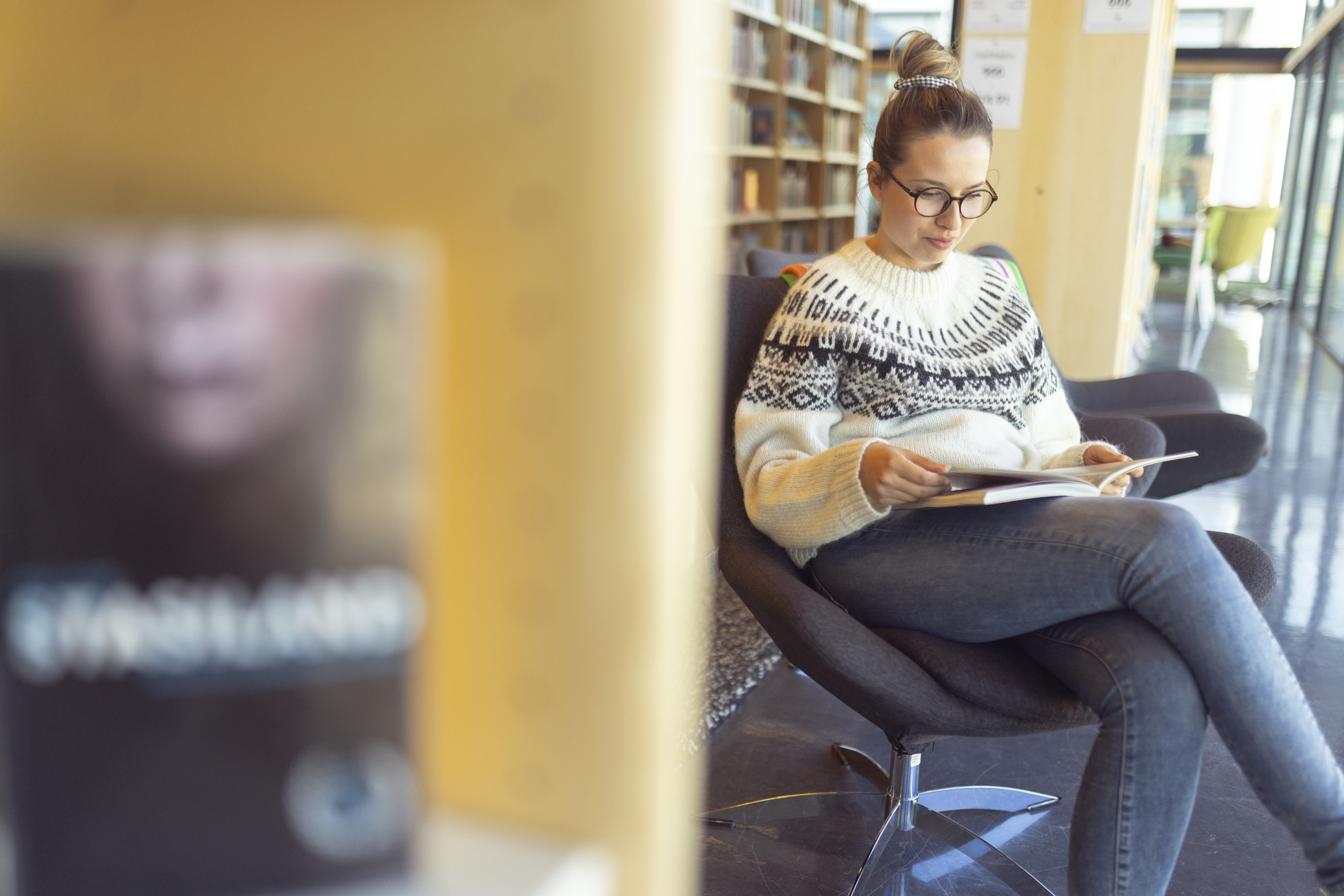 A person reading a book in a library