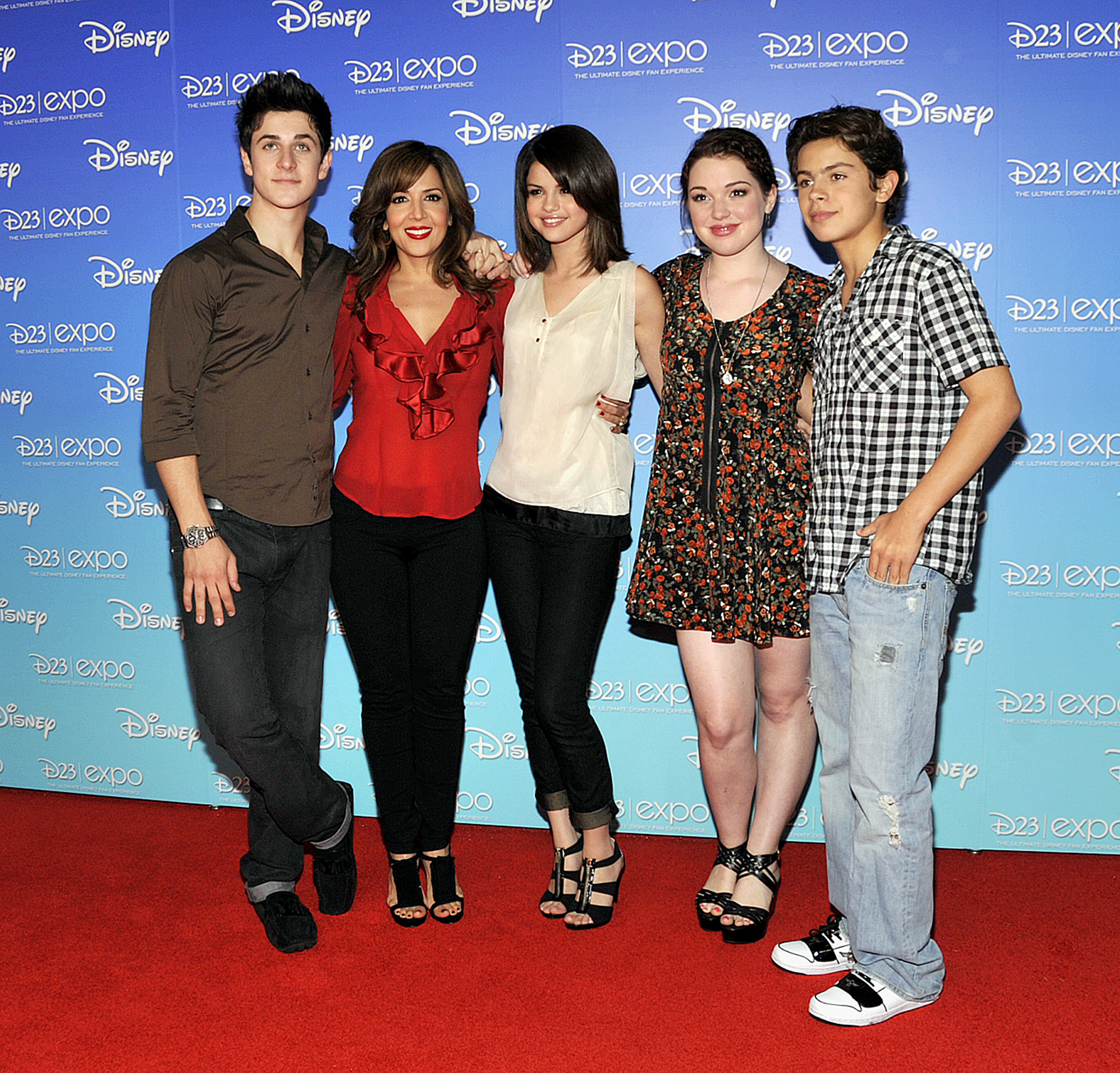 The cast poses together on a red carpet